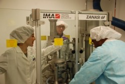 PDS staff adjusting a capsule machine. Photo courtesy of NIH